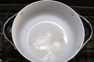 Medium size pot with oil and salt, step 2 of the Dominican Style Long-grain white rice recipe