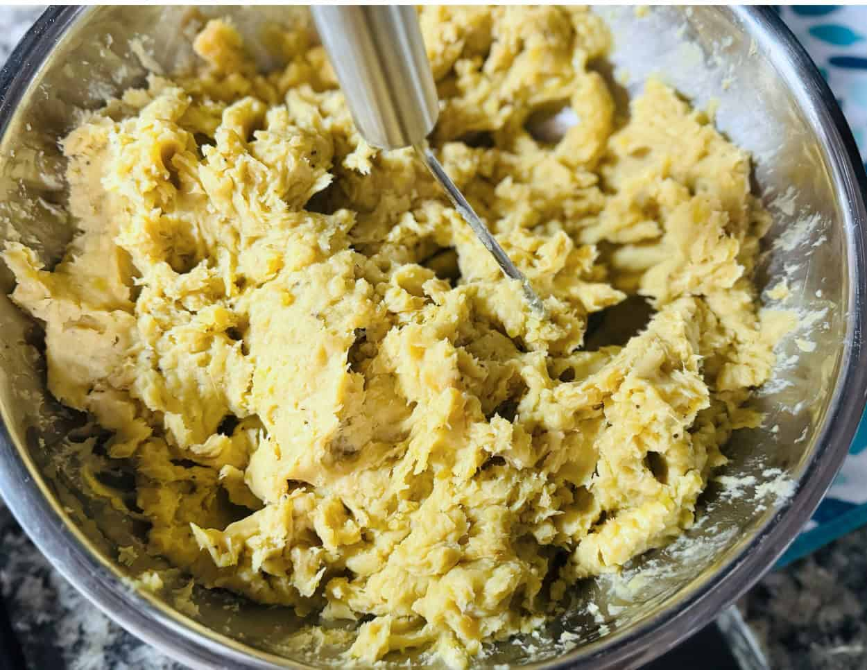 Smooth mashed plantains in a mixing bowl, fully blended and ready to serve.