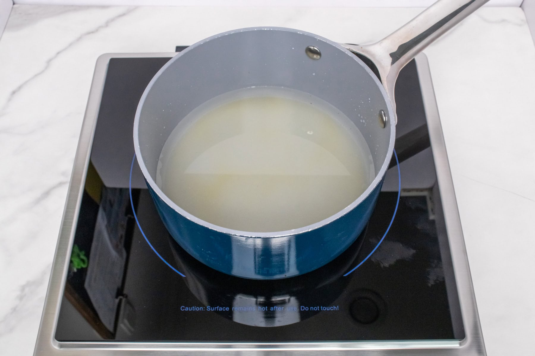 Sugar and water heating in a saucepan for homemade simple syrup