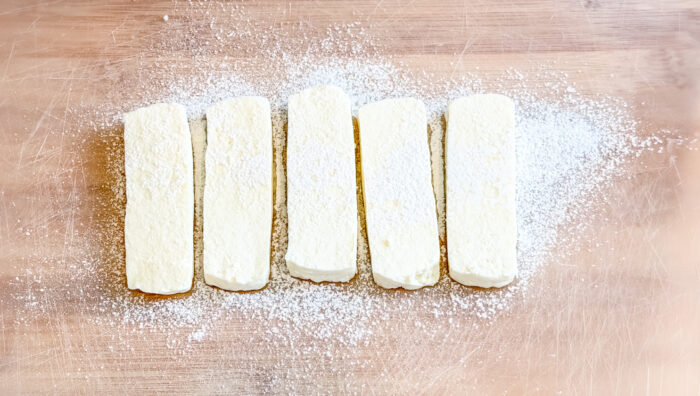Dominican fried cheese slices lightly dusted with flour before frying